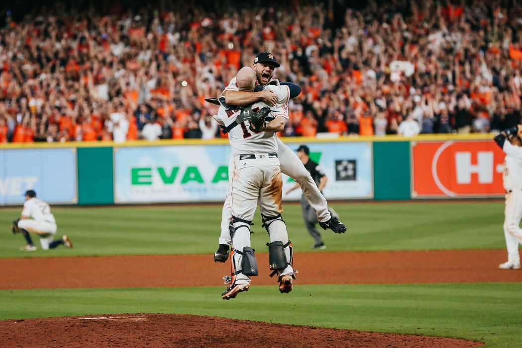 Two Astros players celebrating a playoff win.